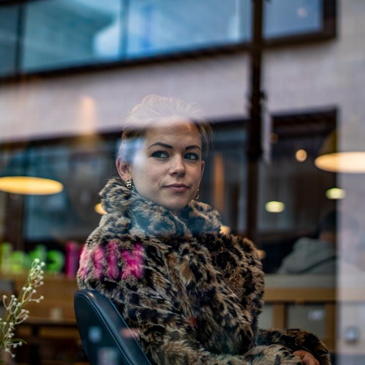 Asha Kapoor, Lead Design Curator at HarborLeafStudio, reviewing corporate floral arrangements